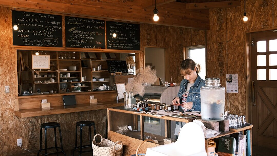 A happy website owner viewing analytics on laptop in a coffee shop