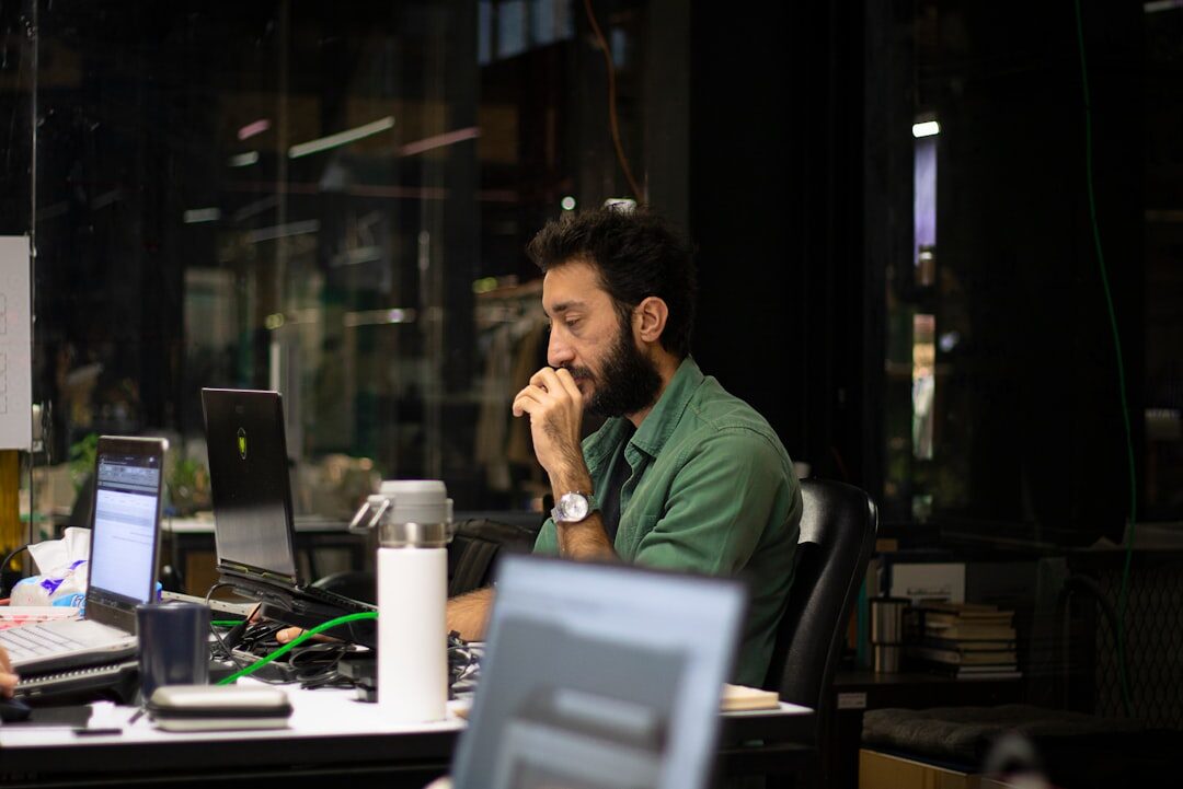 A man working on a desktop computer in a home office