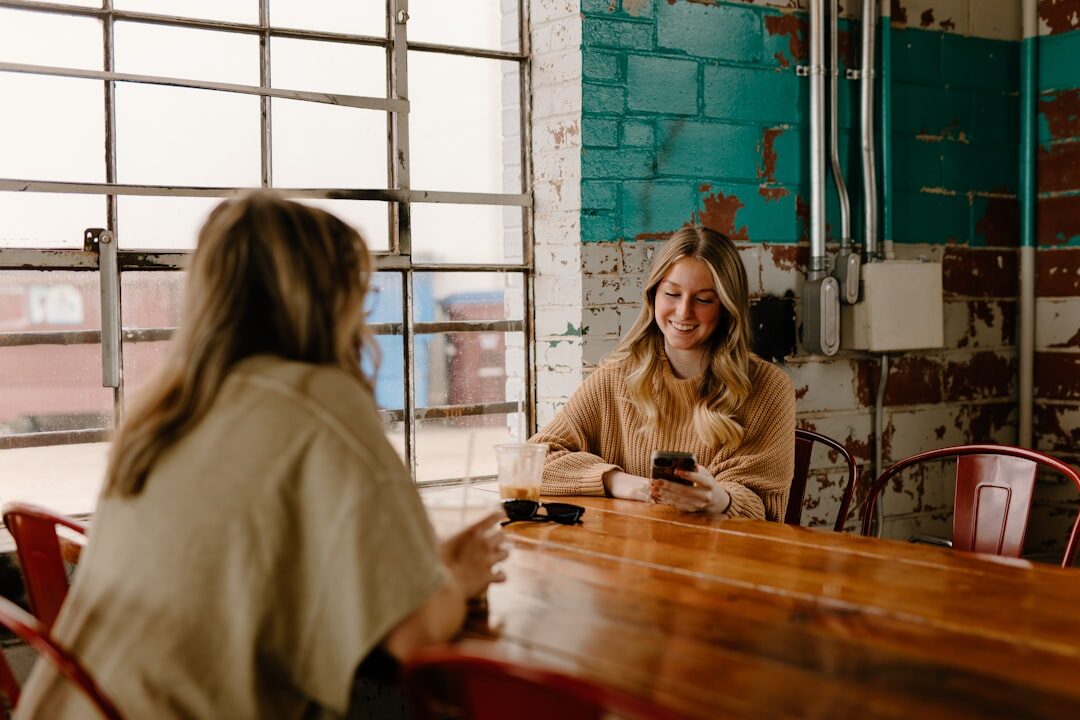 A woman working on a laptop in a coffee shop