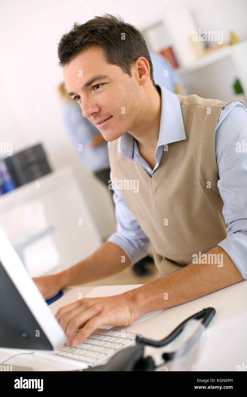man coding on desktop