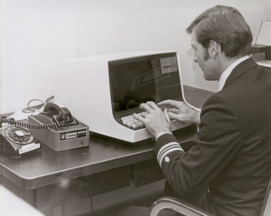 man comparing two laptops in office