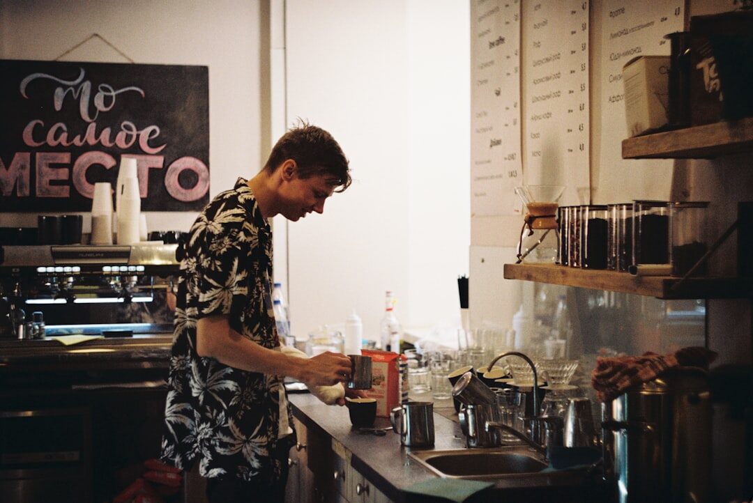 man working on laptop in coffee shop