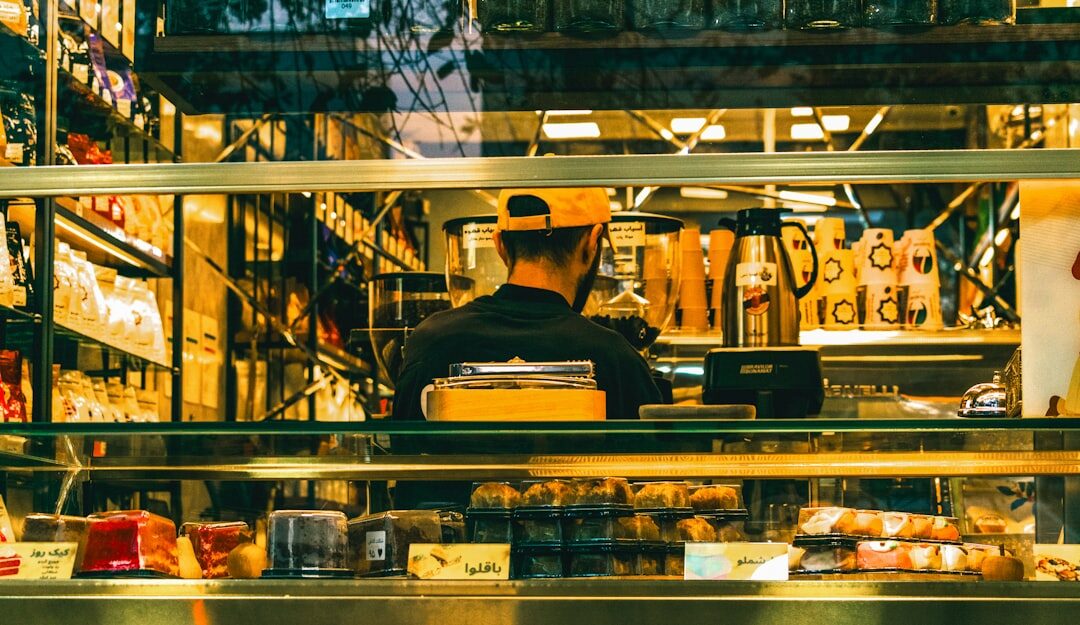 man working on laptop in coffee shop