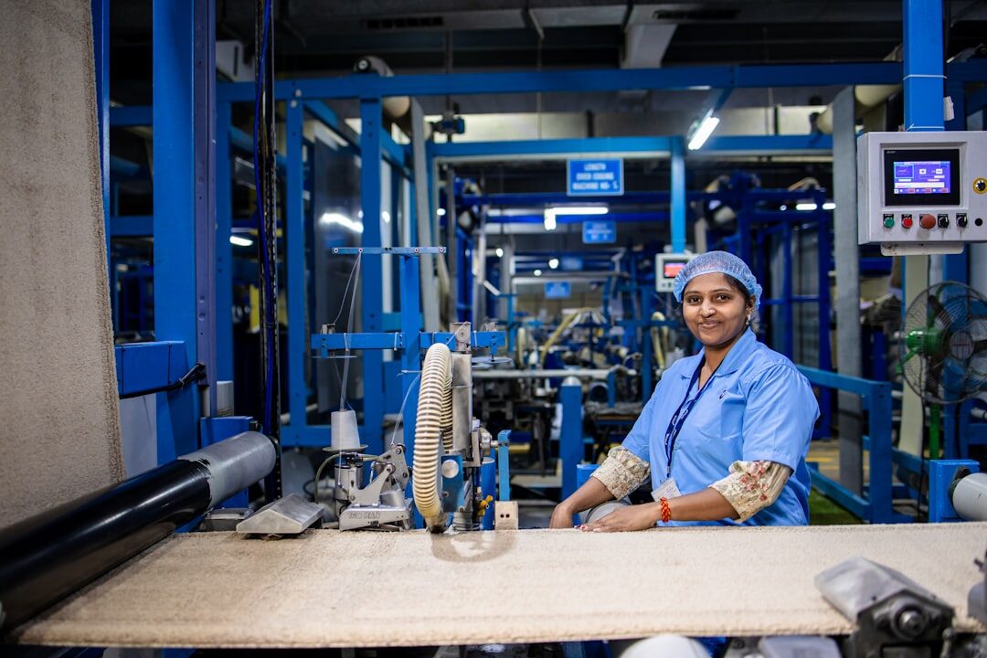 woman assembling robot arm in a factory