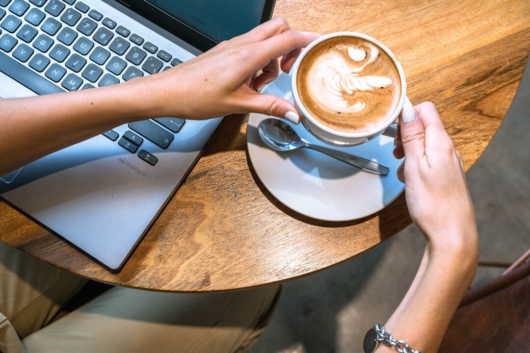 woman typing on laptop in coffee shop