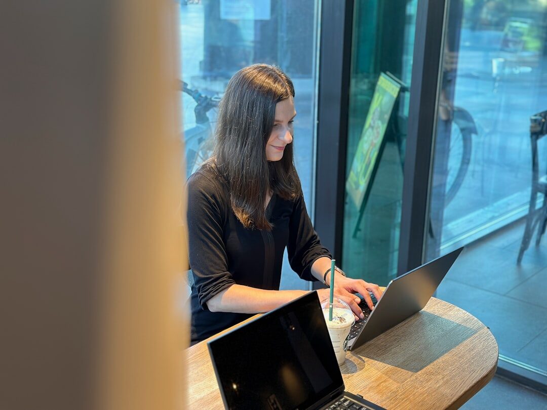 woman working on laptop in coffee shop