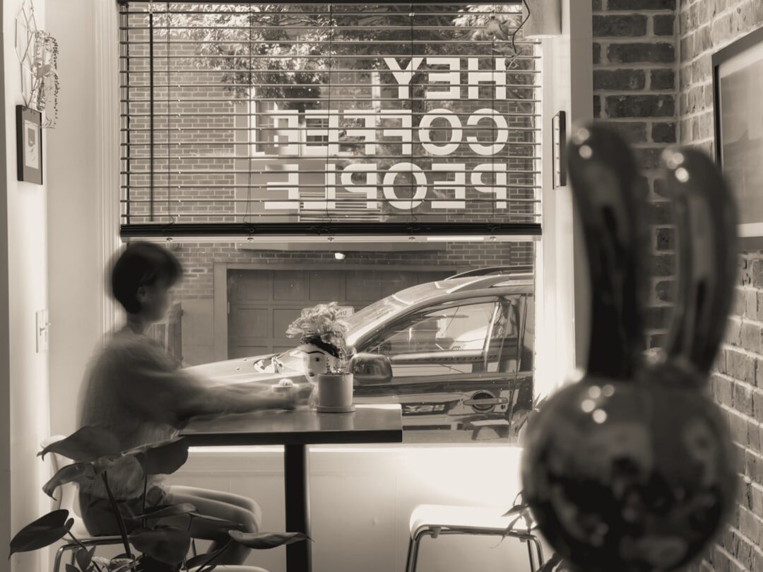 woman working on laptop in coffee shop