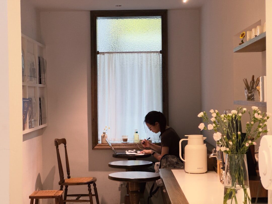 woman working on laptop in coffee shop