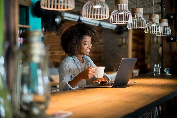woman working on laptop in coffee shop